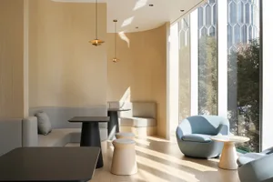 Modern cafe interior with neutral-colored materials and contemporary furniture.