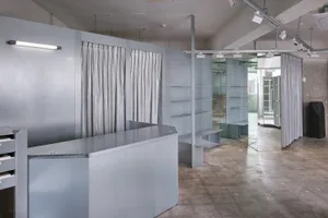 A minimalist office space featuring metallic walls and furniture