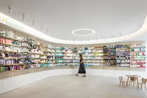 A modern retail store interior with wooden shelves, glass display cases, and metal fixtures.