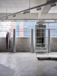 An industrial interior space with metallic lighting fixtures and minimalist design elements.
