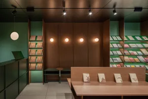 A modern library interior featuring wooden shelves and books.