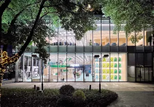 Modern retail storefront featuring glass, steel, and concrete materials.