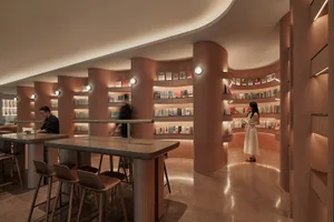 A modern bookstore with minimalist design, featuring concrete walls and floor.