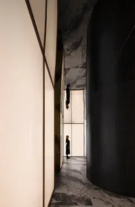 A minimalist interior design featuring marble and glass panels