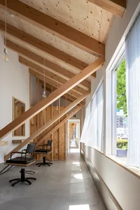 Light-filled office space with minimalist design, featuring wood elements and large windows.