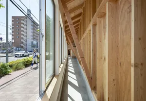 Modern interior design featuring a hallway with wooden frame and large glass windows.