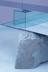 A modern stone table with a minimalist design in a contemporary interior setting.