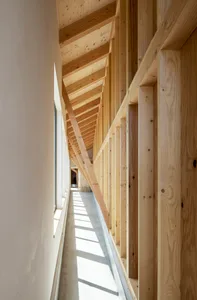 Modern interior with white walls, concrete floor, and wooden beams and panels