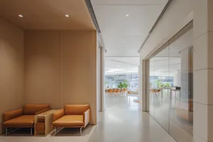 A modern lobby area featuring wood-paneled walls and leather seating.