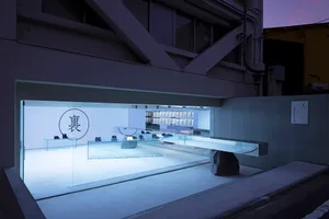 A minimalist retail space featuring modern concrete and glass materials.