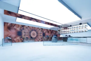 A minimalist retail store display featuring glass and concrete materials.