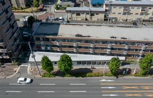 An overhead view of an urban landscape featuring a building with concrete and glass structures.