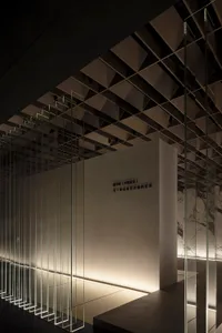 A minimalist interior featuring glass, concrete, and wood elements.