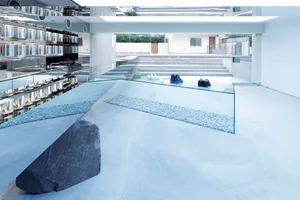 A minimalist storefront featuring glass elements.
