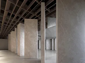 Modern exhibition gallery space featuring granite columns