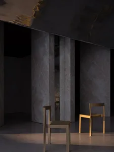 A minimalist room featuring modern furniture and concrete elements.