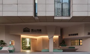 An entrance to a modern lobby with a concrete facade.