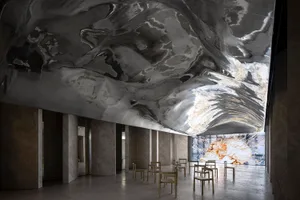 Modern lobby with marble walls and concrete ceiling