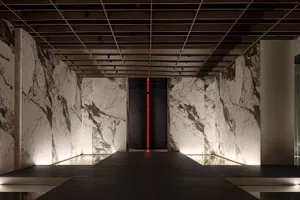 A modern retail space featuring marble walls and a sleek, minimalist design.