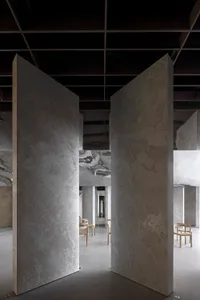 Modern restaurant interior featuring marble walls and floors.