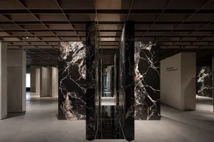 Interior space with modern design elements featuring marble and concrete materials.