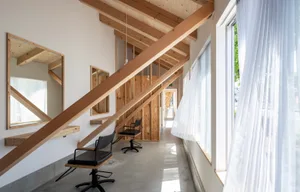 A minimalist interior design featuring a concrete floor and wooden architecture elements.