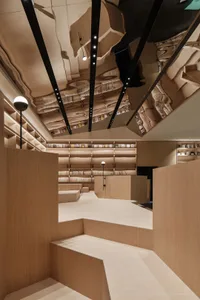 Modern, minimalist library with wooden shelves and lighting.