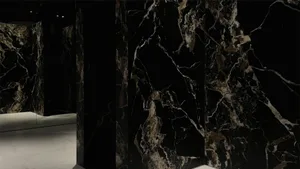 A modern living room featuring black marble walls and flooring.