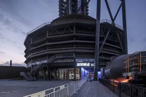 Readership Center with industrial design features, including reused metal and concrete materials, located in an urban setting