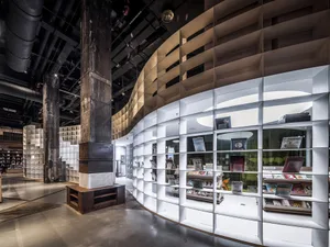 A modern bookstore with metallic shelves and glass panels