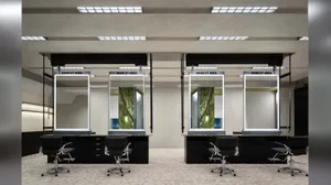 An interior design of a hair salon featuring modern metal-framed mirrors.