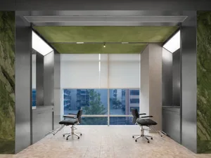 Modern salon interior featuring black chairs, glass walls, and greenery