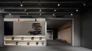 Industrial-style retail storefront with concrete walls and black metal accents.