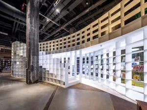 A modern bookstore with white paneling and lighting