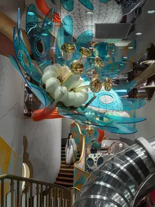 A modern interior space featuring glass, metal, and plastic elements.