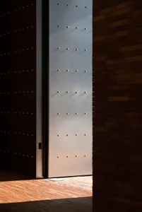 A modern interior featuring wooden walls and metallic accents.
