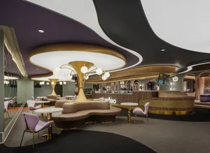 Modern restaurant cafe featuring metallic lighting, flooring, and leather furniture.