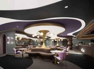 Modern restaurant interior with metal lighting fixtures and contemporary furniture.