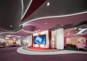 A modern retail space with a futuristic design featuring metallic elements and a curved canopy.