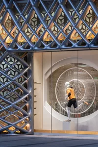 Modern retail storefront featuring a mesh-like metal facade