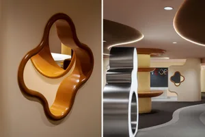 Modern lounge area featuring metallic elements, wooden seating, and glass partitions.