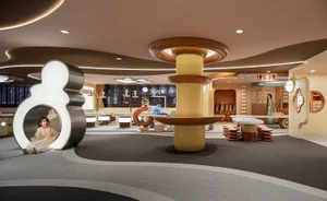 A modern playroom with wooden furniture and playful geometric shapes.