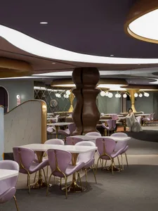A modern restaurant with metallic furniture and walls.