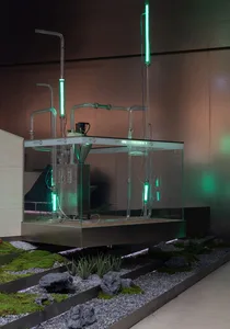 An industrial installation featuring glass tubes and pipes connected to a mechanical device in a modern, minimalist setting.