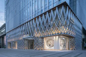 Modern retail storefront featuring a metallic lattice facade