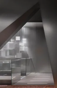 Modern elevator room with glass walls and geometric lighting fixtures.