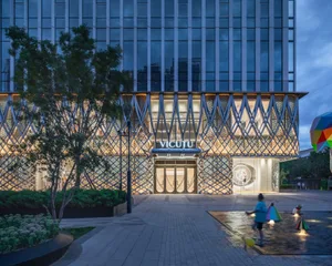 A modern retail storefront featuring glass and metal architectural elements.