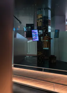 An installation featuring technological video displays and interactive elements within an indoor space.