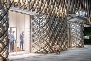 Modern storefront with metallic texture and intricate diamond pattern
