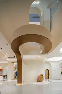 A modern retail storefront featuring metallic columns and a clean, open design.